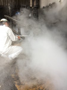 Alternate angle of crew member performing dry ice blast cleaning
