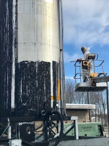 National Industrial Maintenance crew member dry ice blast cleaning an exterior tank